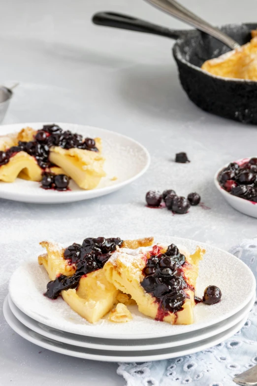 a crepe with blueberries and powdered sugar on top