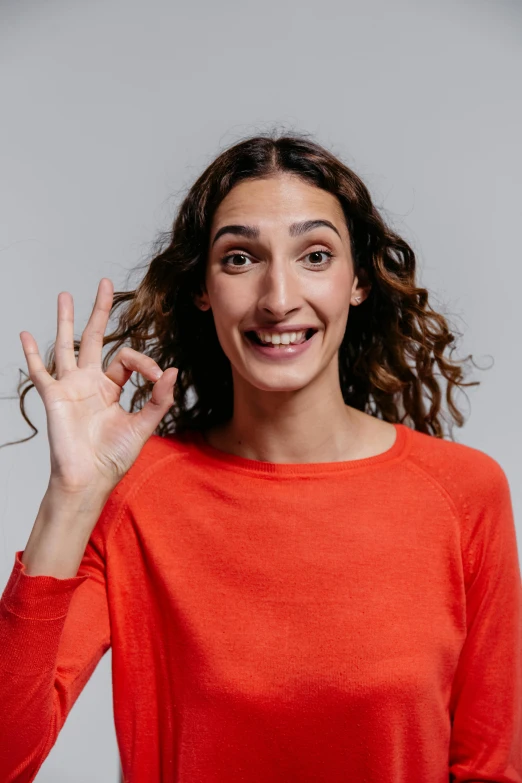 a woman making an okay gesture with her fingers