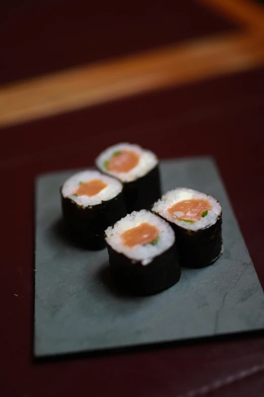 sushi is laid out on a square plate