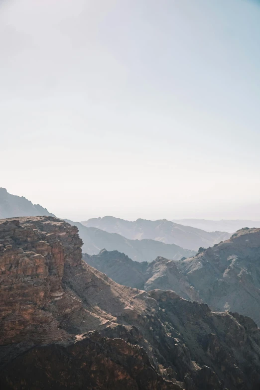 a man stands on the edge of a cliff