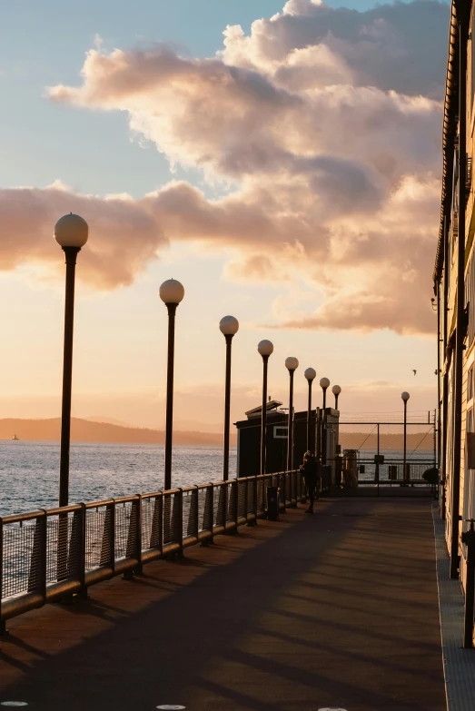 the street lamp is on beside the ocean