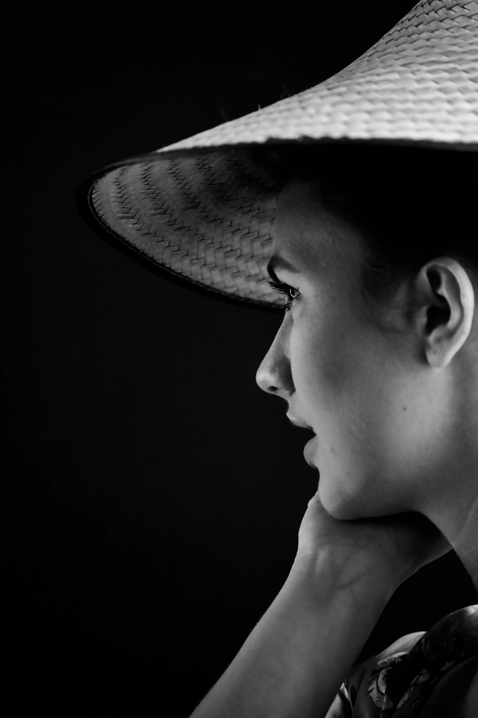 a young woman wearing a hat sitting down