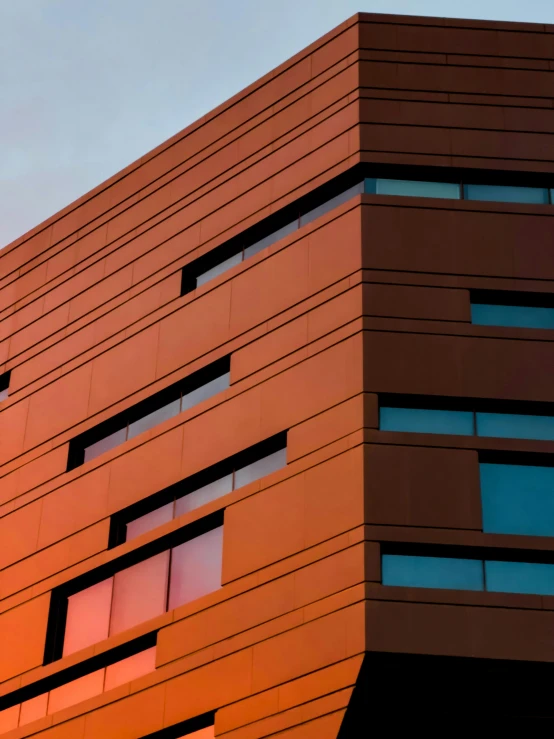 a red building is shown with windows and a clock