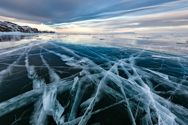 the frozen sea under a cloudy sky with ice