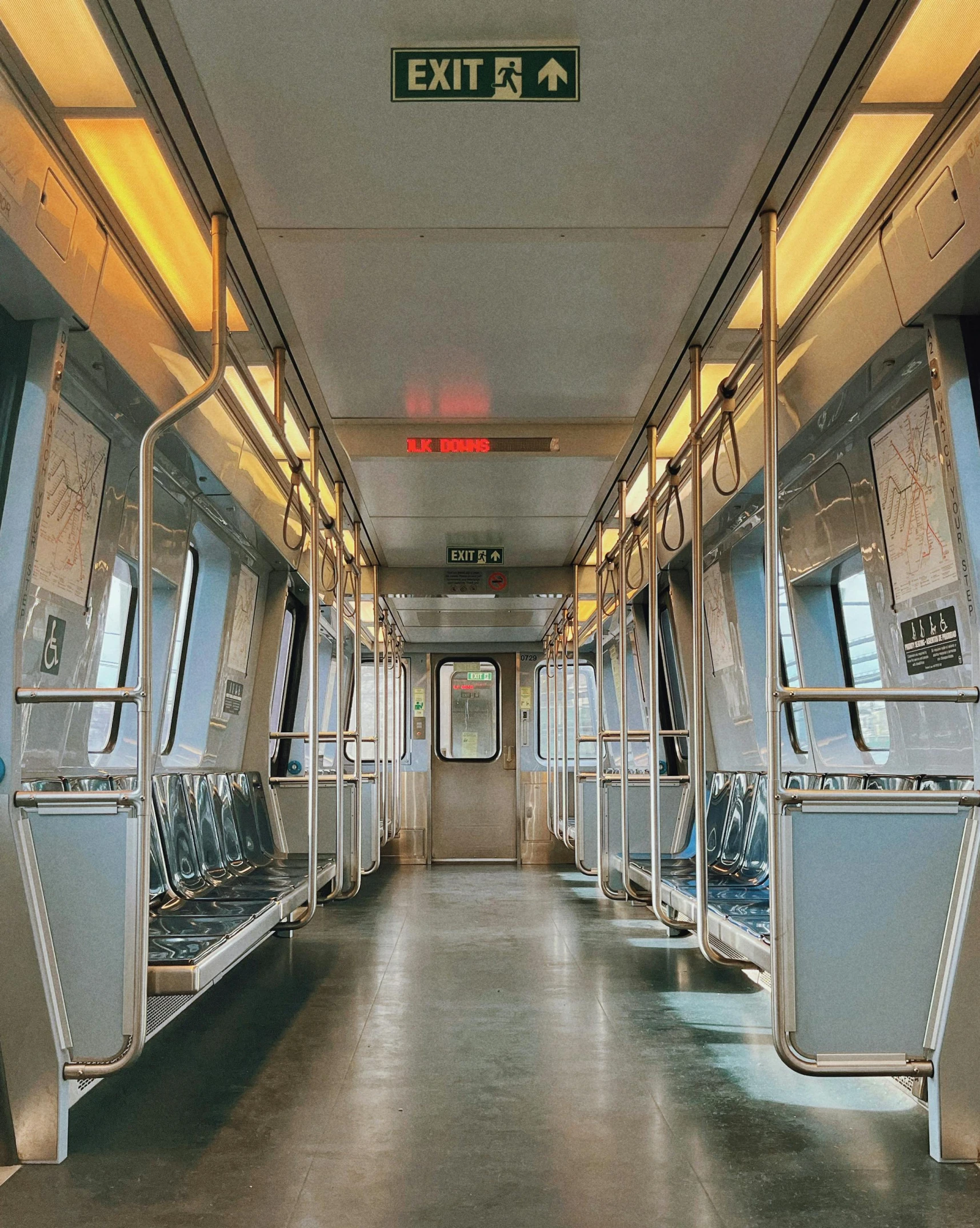 a bus filled with lots of metal seats next to windows