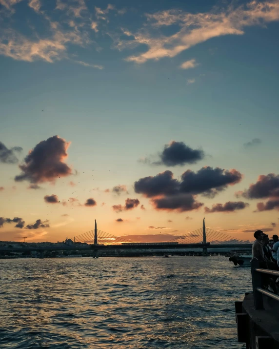 a ferry traveling along a river at sunset