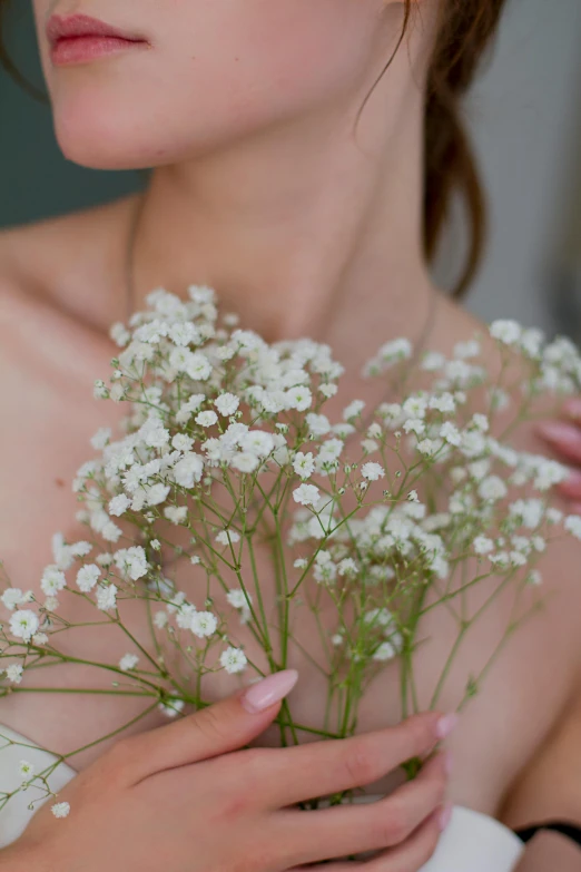 closeup view of the shoulder of a young woman holding flowers