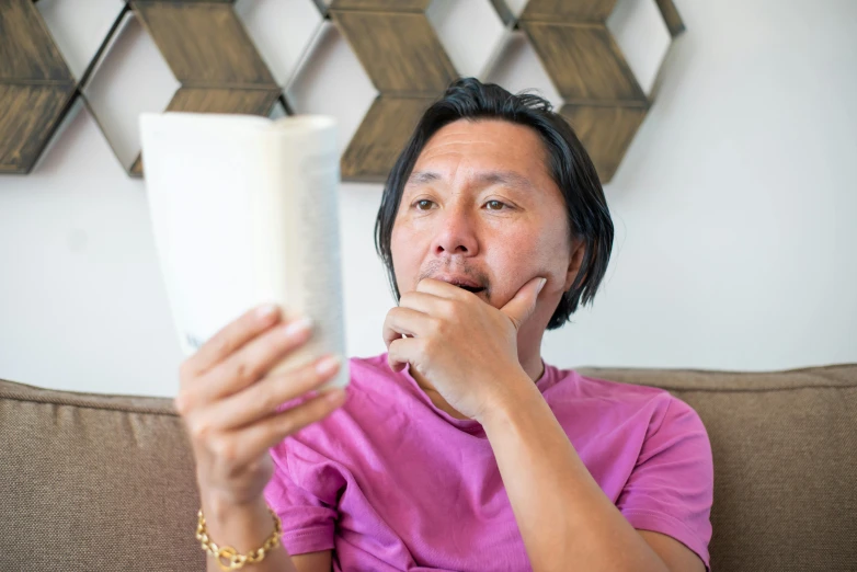 a man is reading his paper in front of him