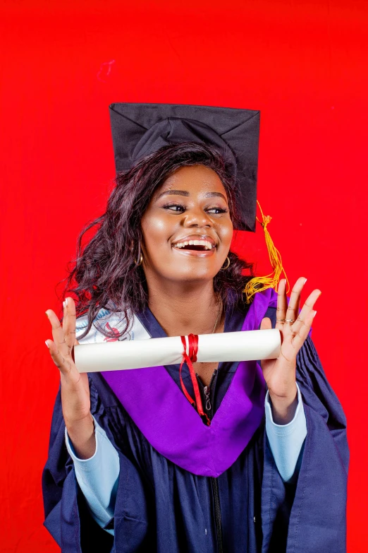 a young woman in a graduation gown holding a diploma