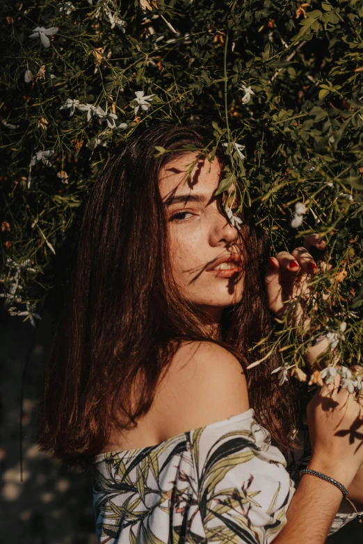 a woman holding a flower with an open face