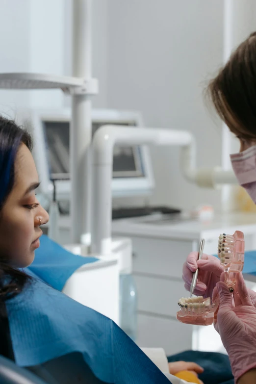 a woman getting her teeth checked for dental care