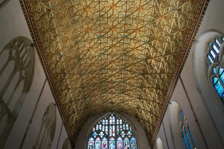 a large ornate ceiling inside of a church with stained glass