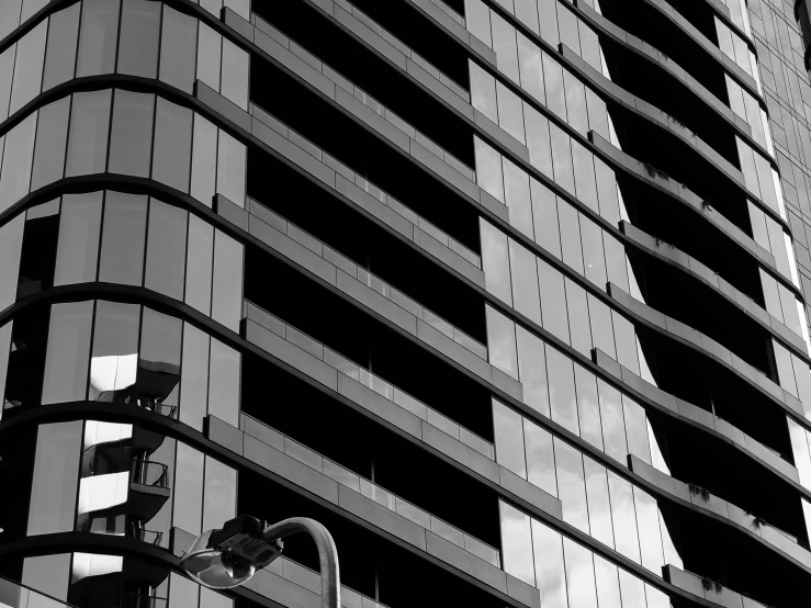 a black and white image of the corner of a tall building