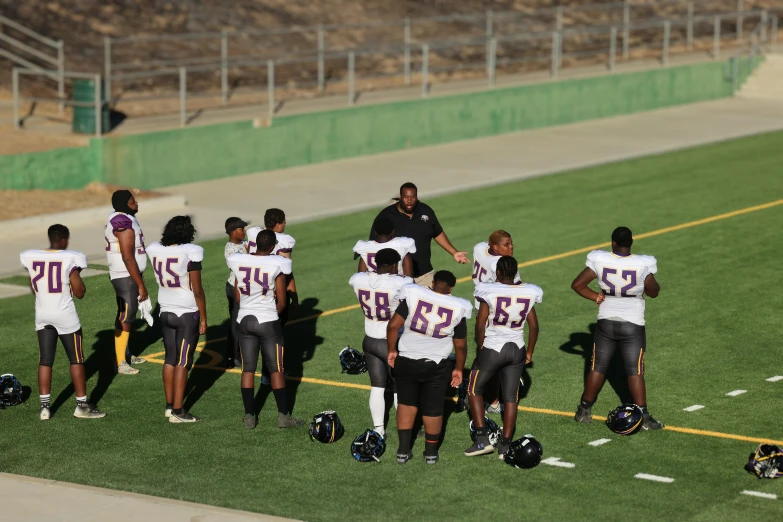 the football players are huddle together during a game