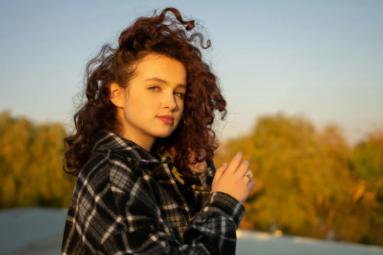 a woman that is holding her hand up with some kind of hair