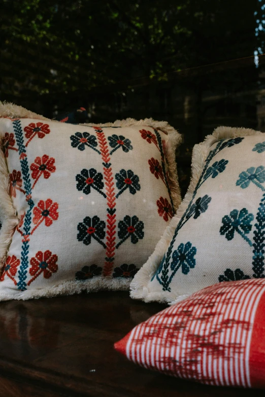 two pillows are lined up on the side of a table