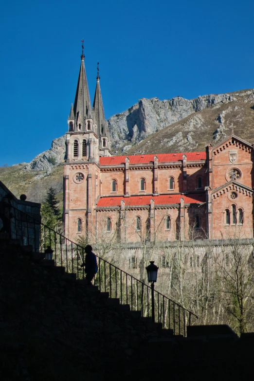 two men are walking toward a stone building