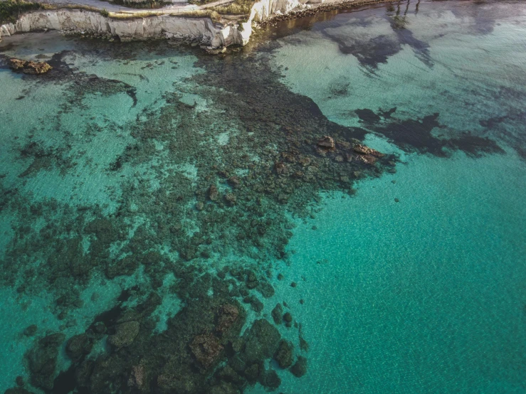 an aerial view of the waters off of a coastal island