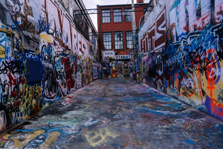 graffiti covers the walls of an alleyway