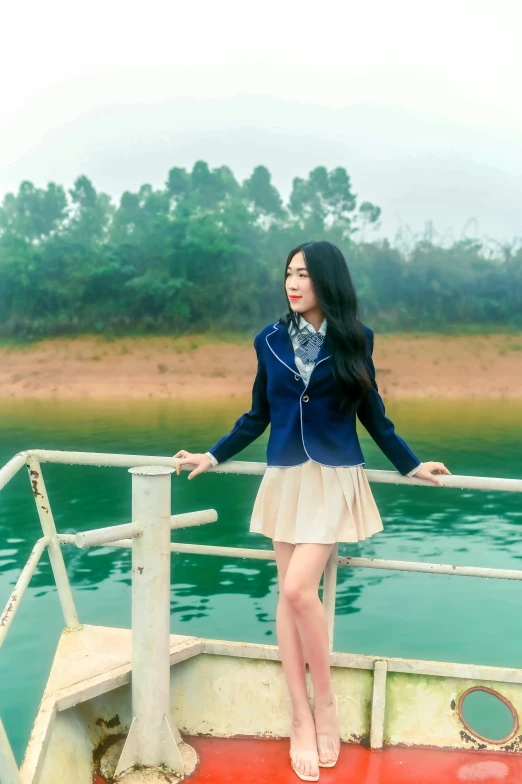 a woman standing on a boat with her hand on the railing