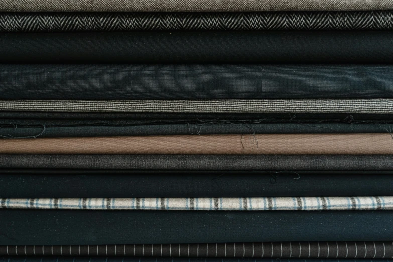 six folded fabrics are stacked on top of each other