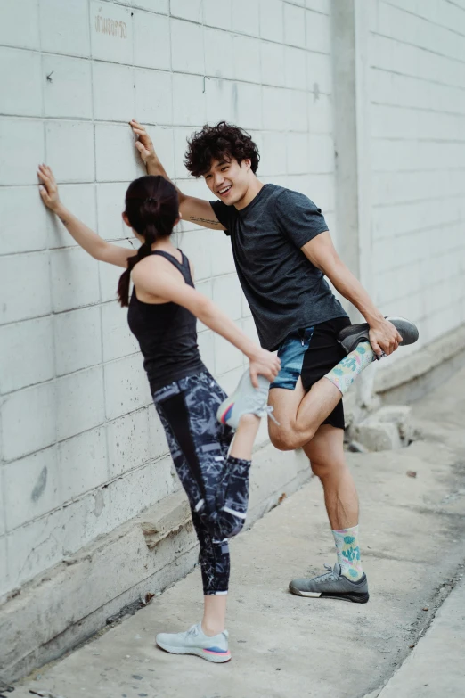 a boy is holding onto a skateboard on the street