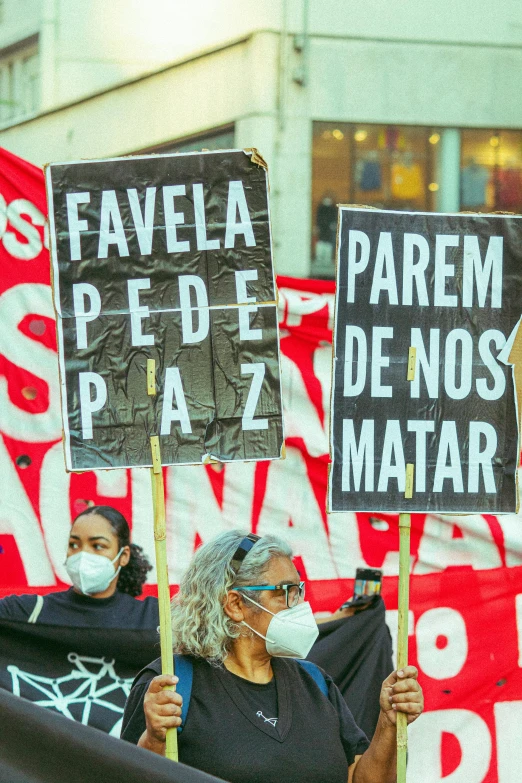 some people holding protest signs in front of a building