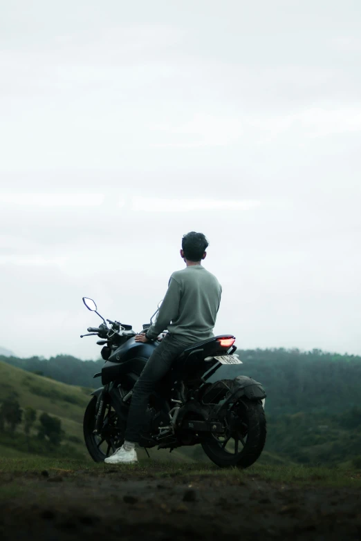 the man is riding his motorcycle outside