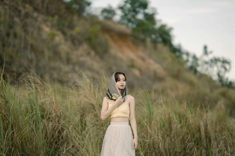 a woman with a scarf around her neck holding a erfly