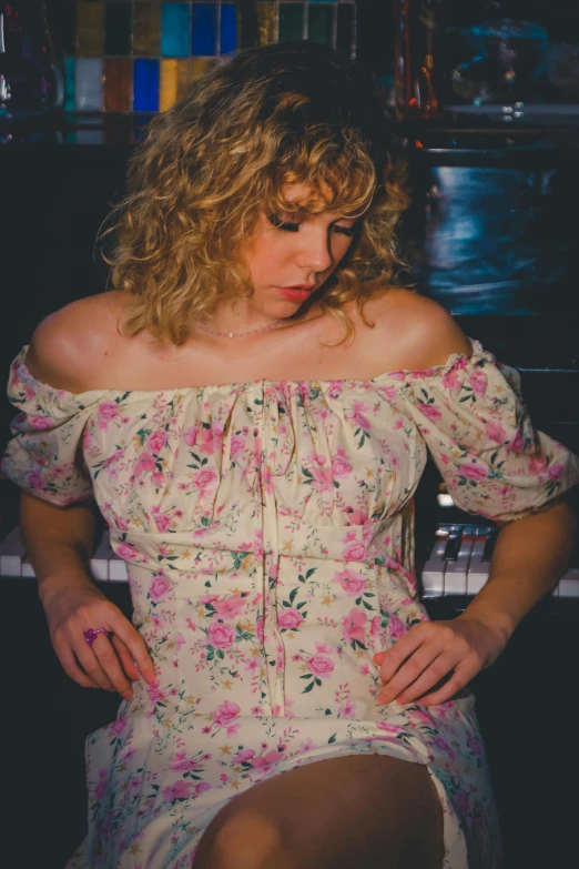 a woman sitting at a piano with her hands on her hip