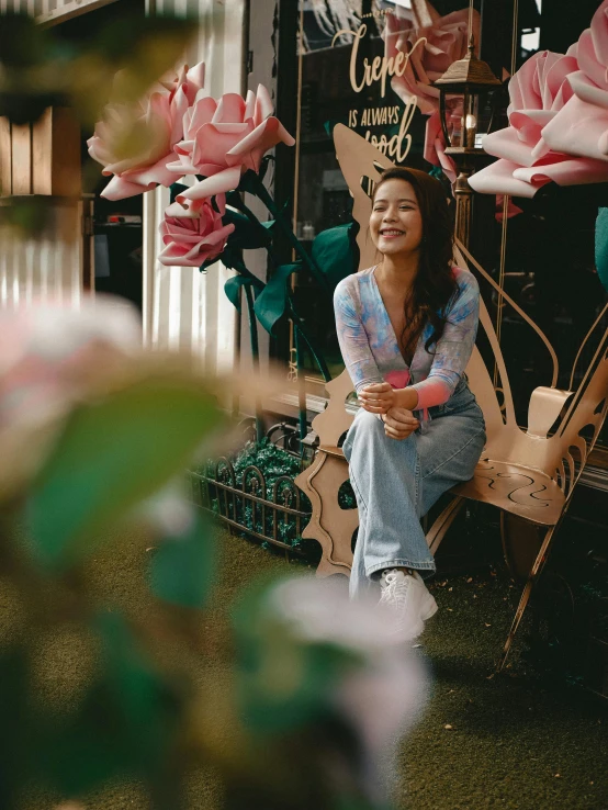 a smiling woman sitting on a bench outside