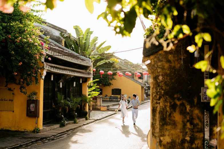 two people walking down an alley between buildings