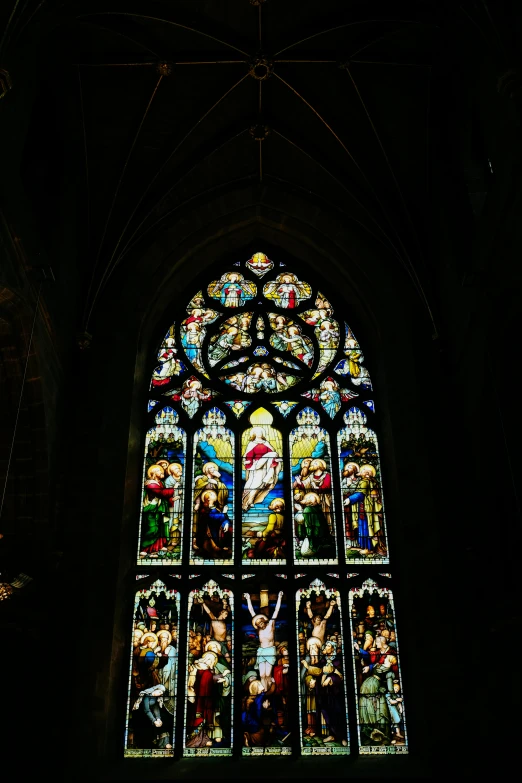 a window with the image of many religious people on it