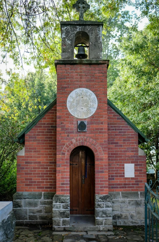 the bell tower has a door and bell for bells