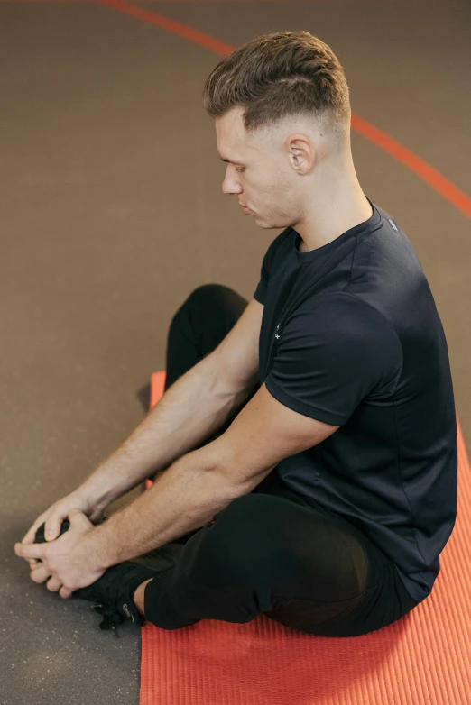 a man is sitting on the ground with his feet in the air