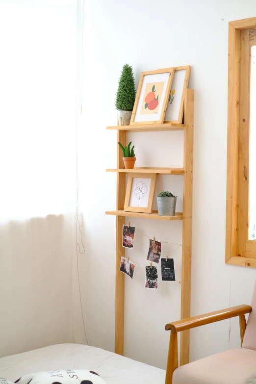 a small shelving unit with pictures and frames around it