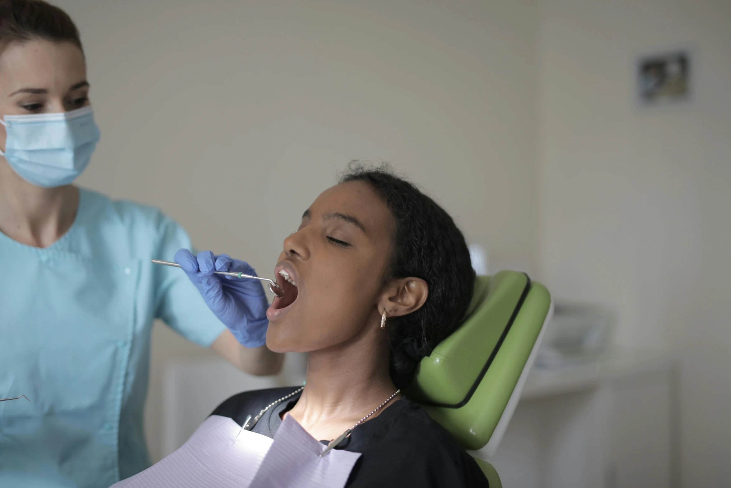 woman with protective mouth cover having her teeth checked