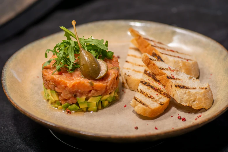 plate of food with bread, pickle and fish