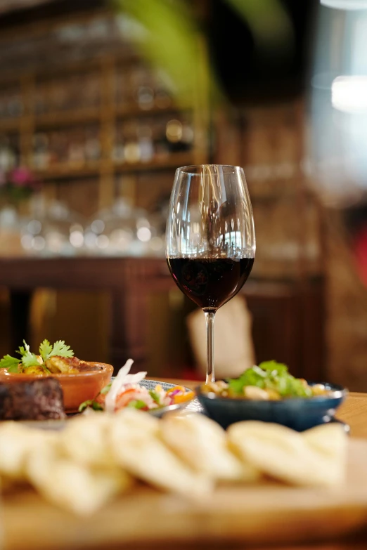 a table with bread and some cups of wine on it