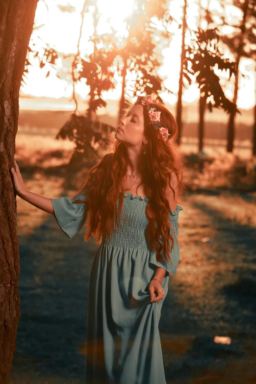 a girl standing by a tree in an image from the series, autumn sunset