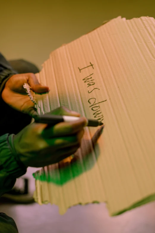 a person holding a pair of scissors in front of a cardboard box