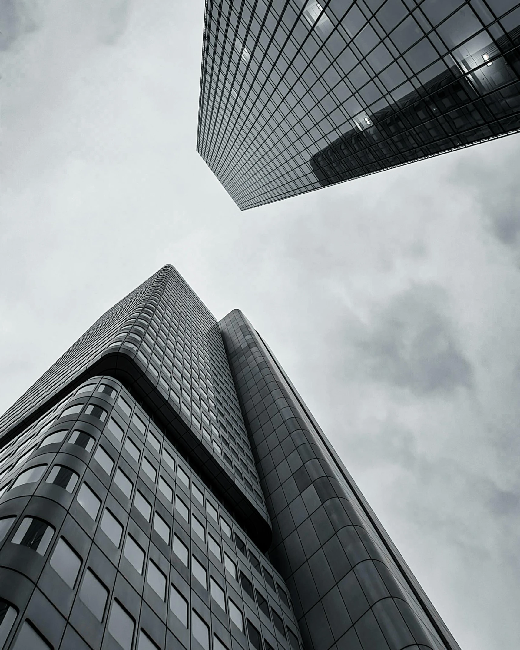 a high rise building against a cloudy sky