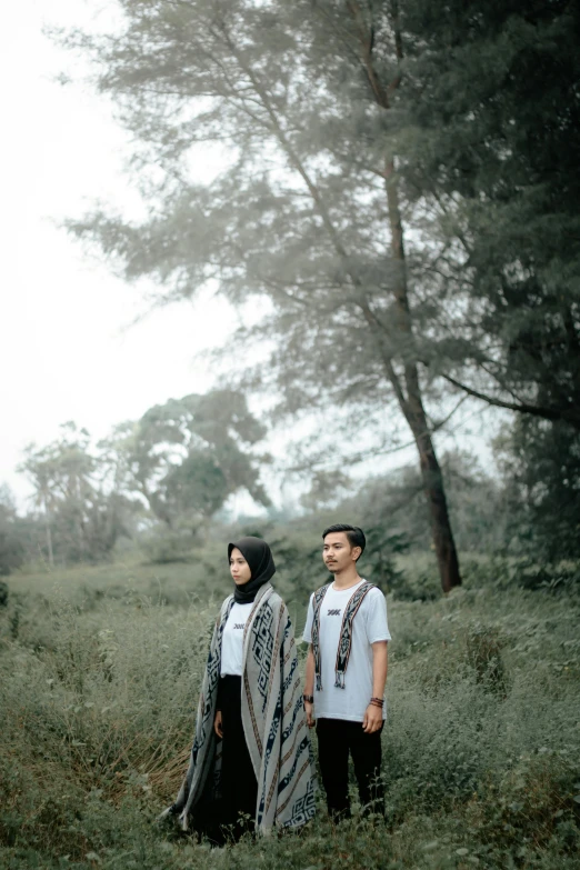 two people stand in the middle of a field