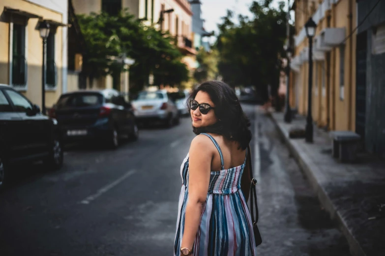 an attractive woman with long hair and glasses on the street