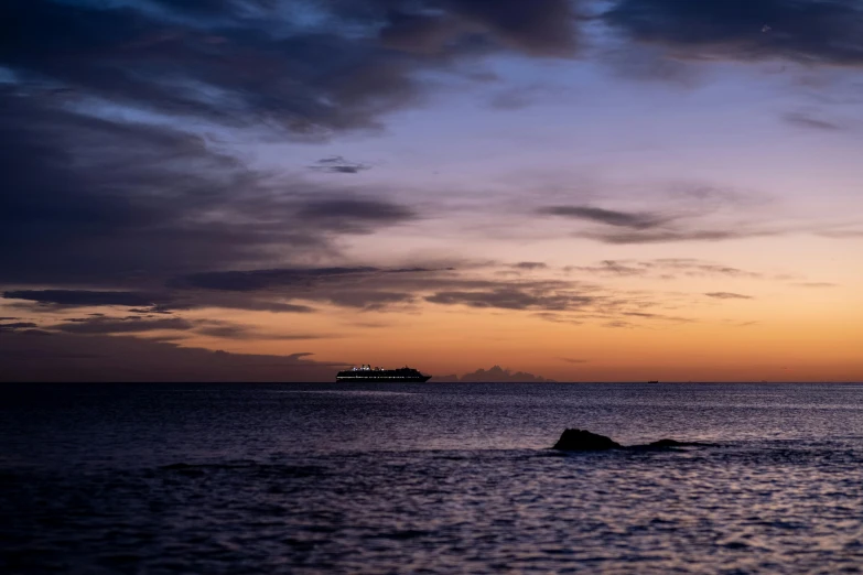 an ocean view with waves and a boat in the background