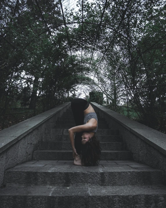 a person on a step doing an upside down trick