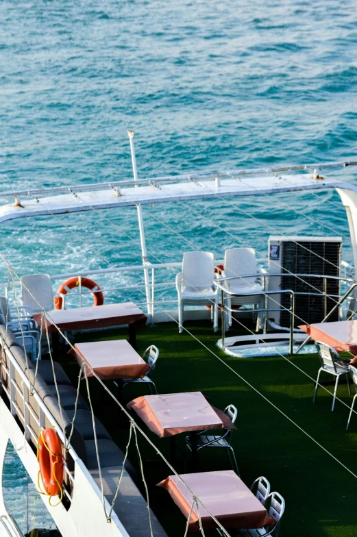 a line of empty tables on top of a boat