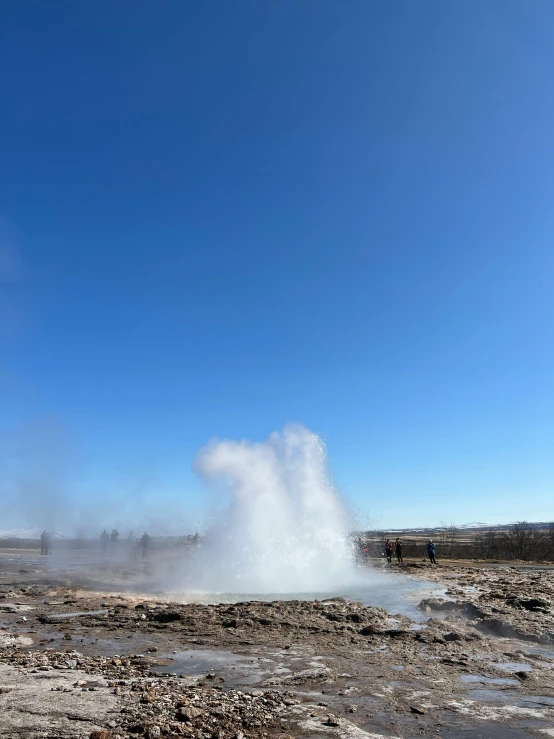 geyser spewing out water on a clear day