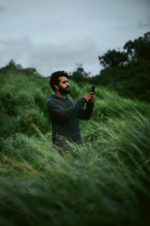 a man takes a po in the long grass