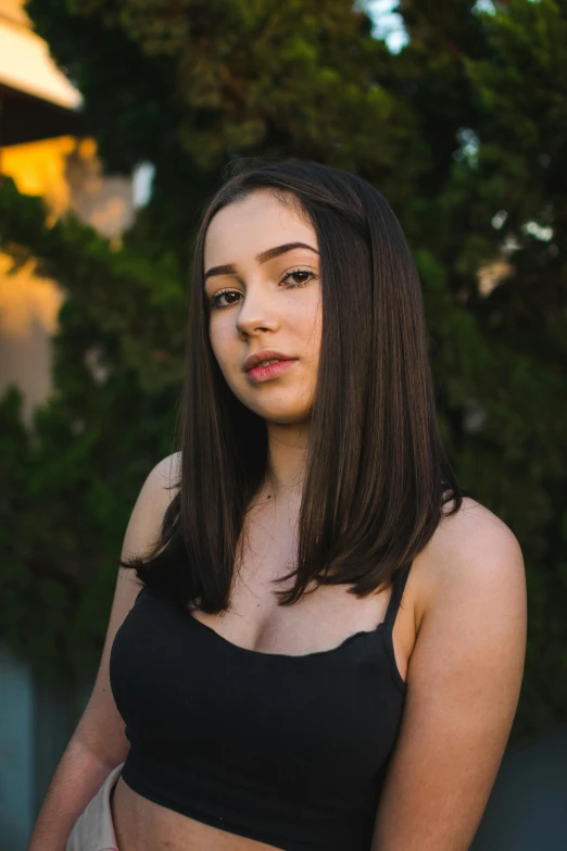 a woman is standing and posing for a picture